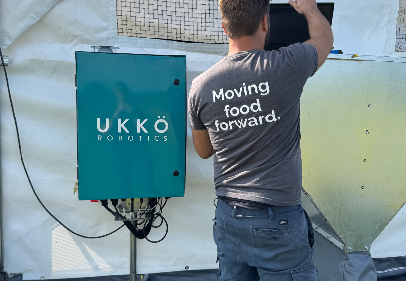 UKKÖ Robotics team member making adjustments to ROVA|BARN.