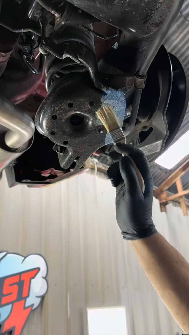 Two technicians smiling infront a vehicle before precision dry ice blasting at IceBlastPro facility.