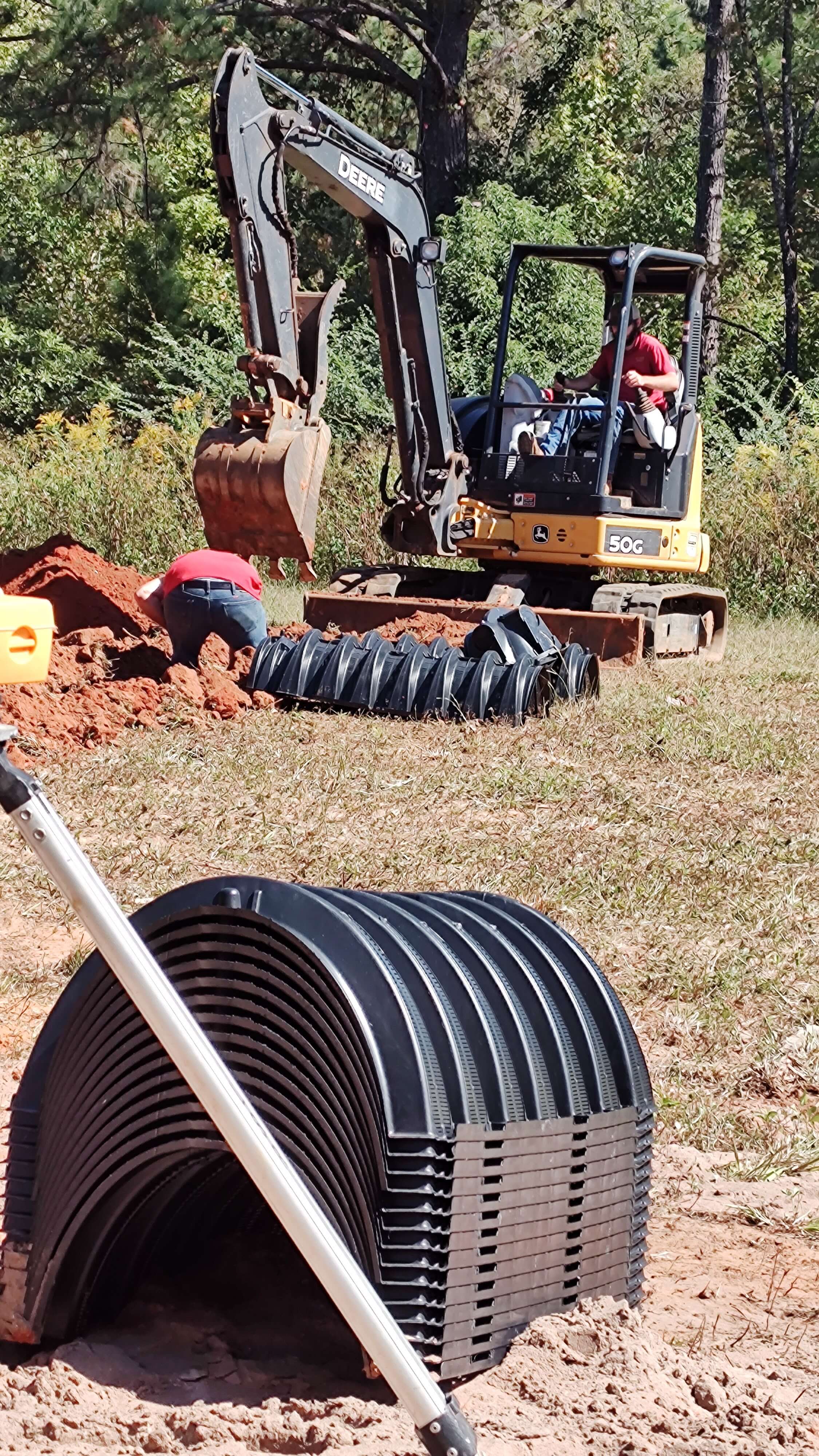 tractor installing pipes