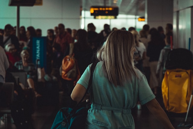 A crowded airport with people waiting to get through security