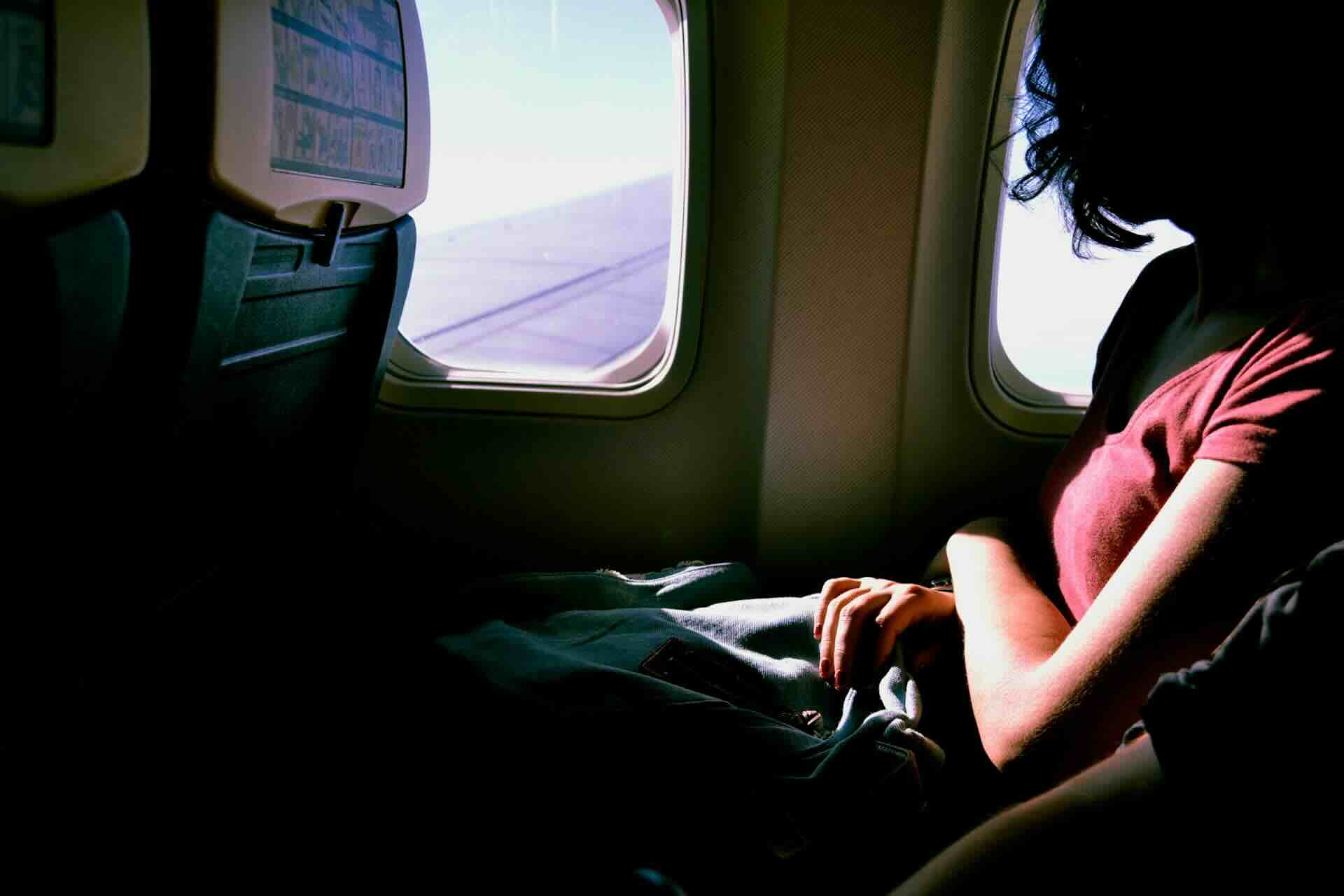 A Woman Looking Out an Airplane Window