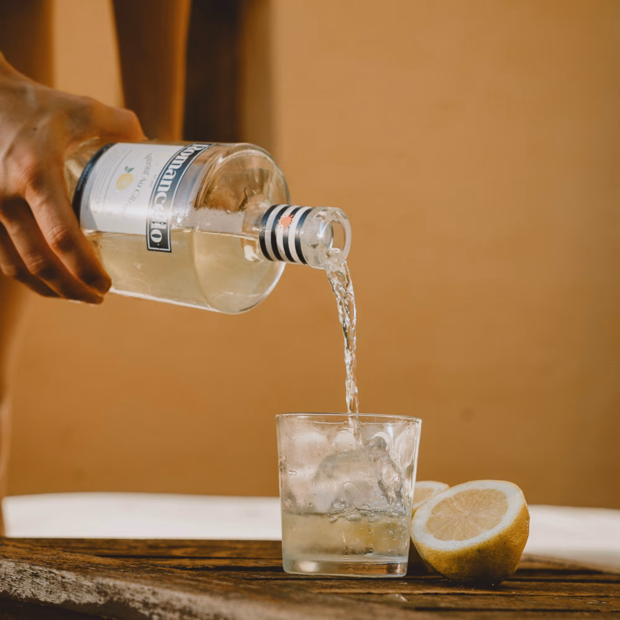 Romancello lemon aperitif served on the rocks with a large ice cube