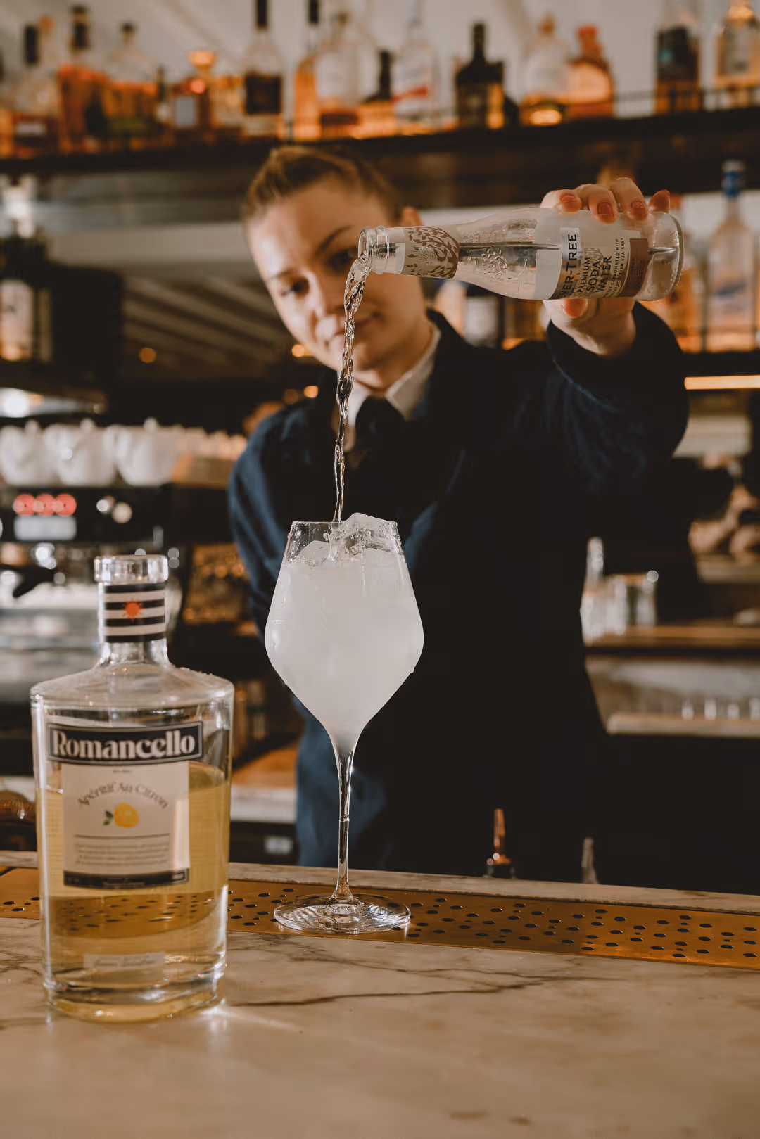 The finished Romancello Spritz — lemon aperitif with soda water over ice