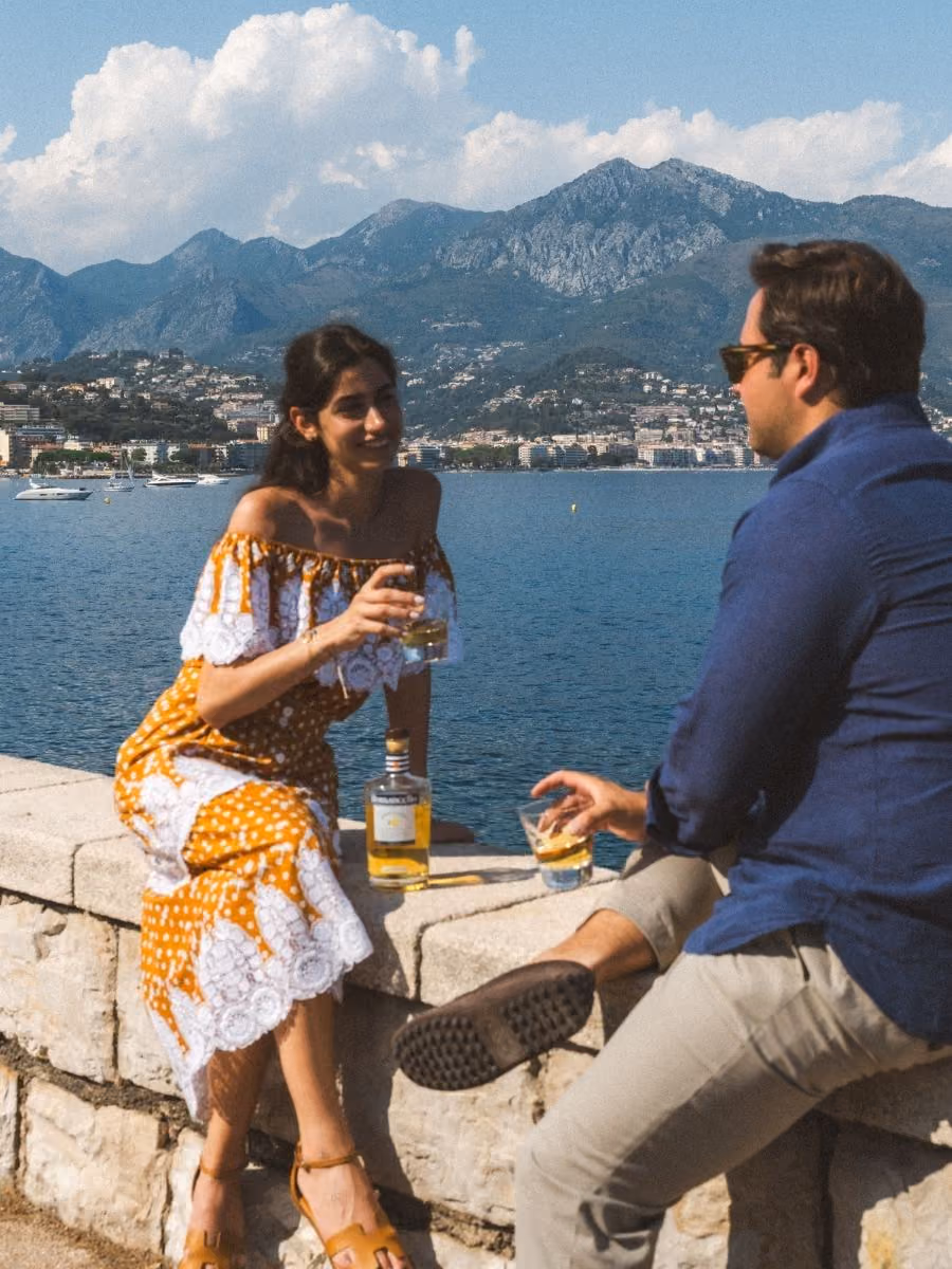 Two friends sharing Romancello over ice on a seafront wall on the Côte d'Azur