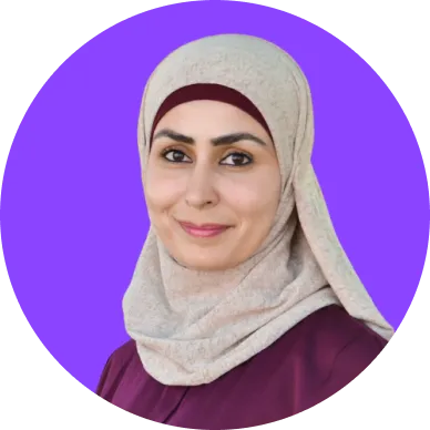 Portrait of a woman wearing a beige hijab and maroon top, smiling against a solid purple circular background.