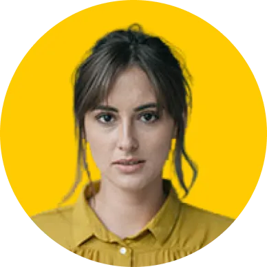 Portrait of a woman with dark hair wearing a mustard yellow blouse against a yellow background.