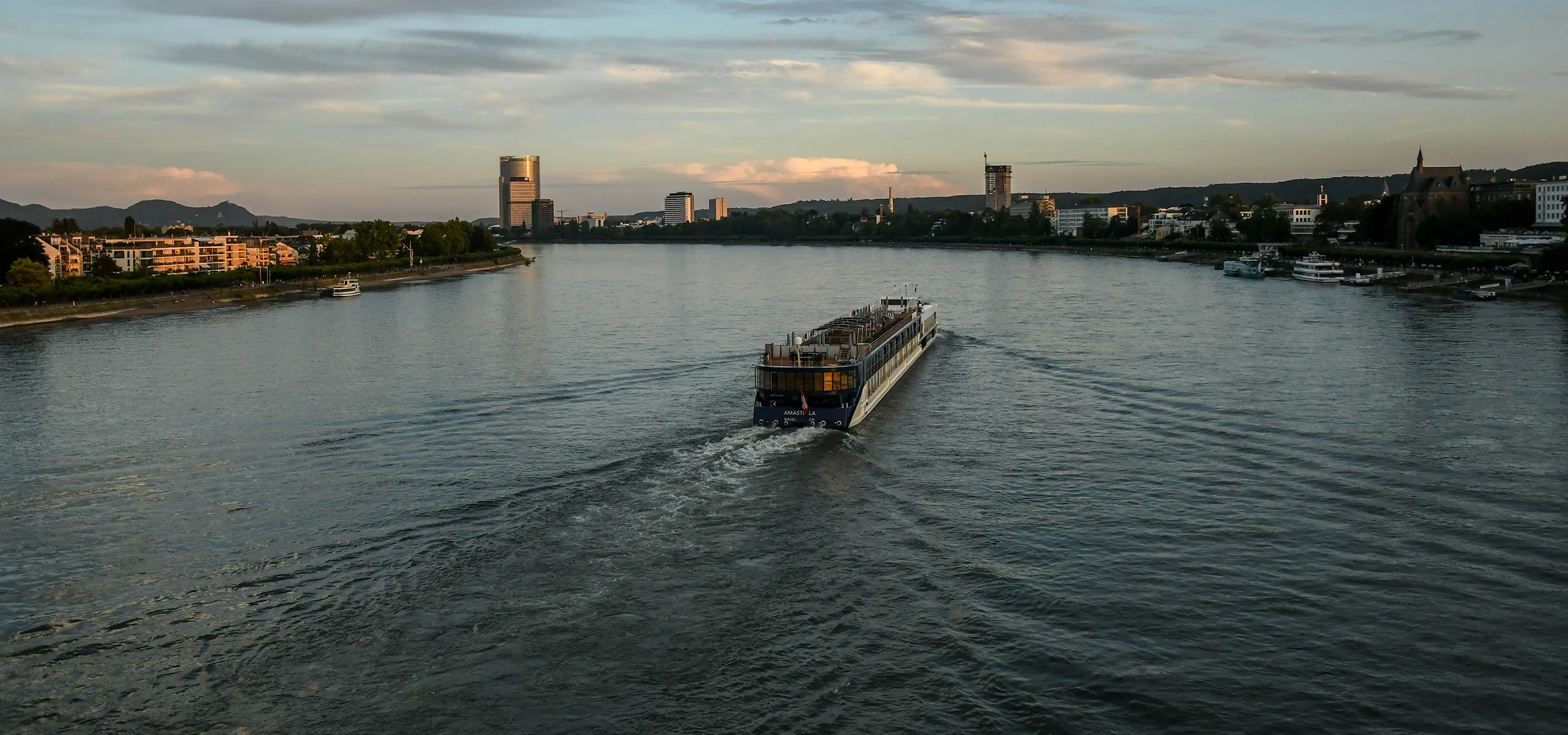 AmaWaterways cruise going through a river in the middle of a city