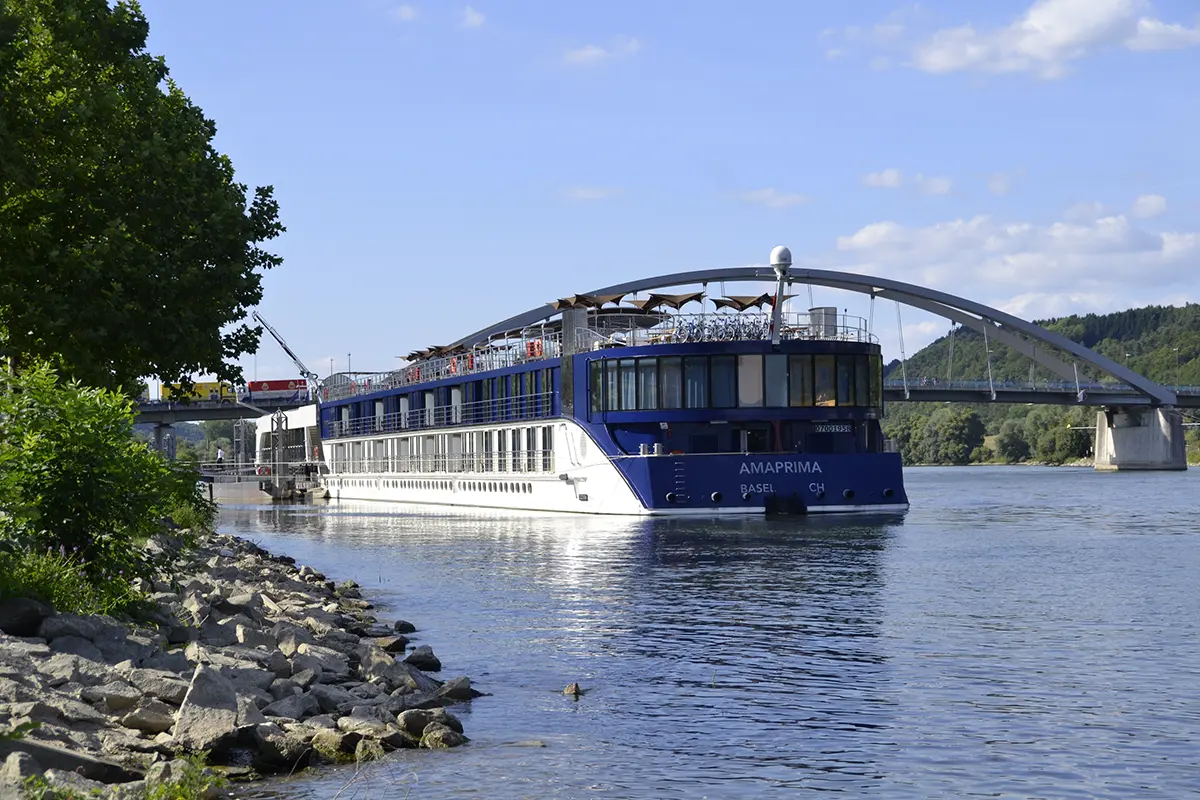 AmaWaterways ship Amaprima sailing next to a bridge