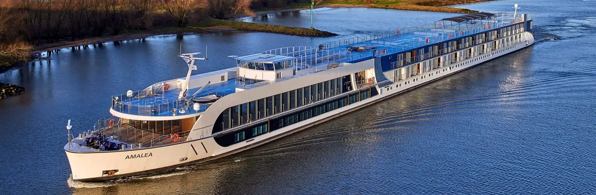 AmaWaterways cruise sailing on a river during fall