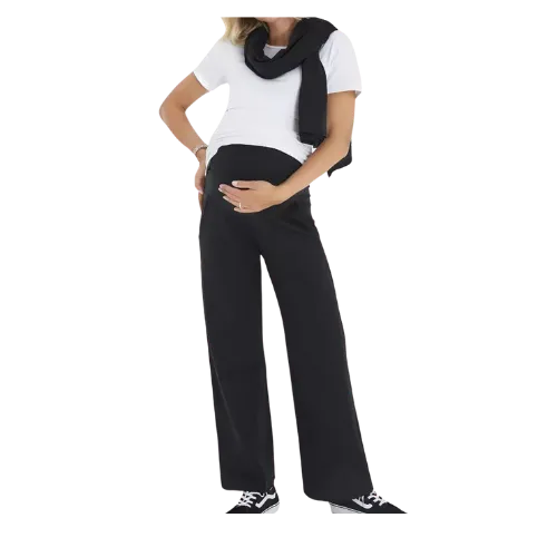 Pregnant woman wearing white shirt, black scarf, and black pants posing.