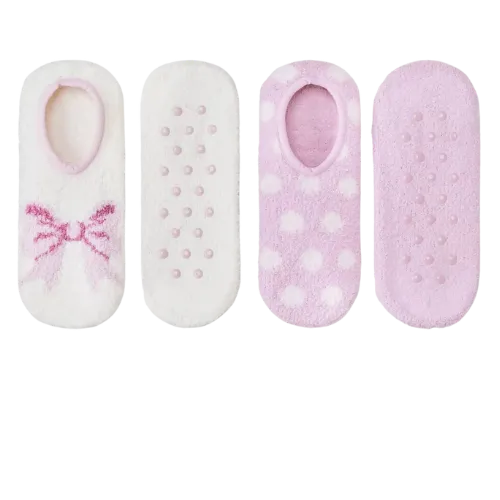 Four pairs of pink and white baby socks with decorative patterns and grips