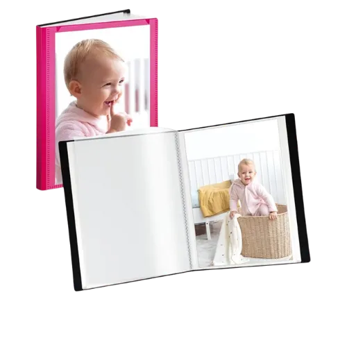 Open photo album with baby images and pink hardcover book displayed