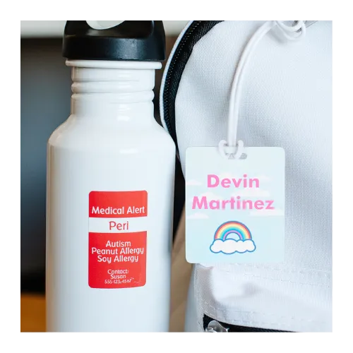 Medical alert water bottle with autism and peanut allergy labels next to child ID tag.
