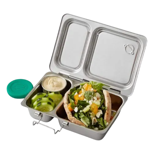 Stainless steel bento box lunch container with green grapes, sandwich, and dressing