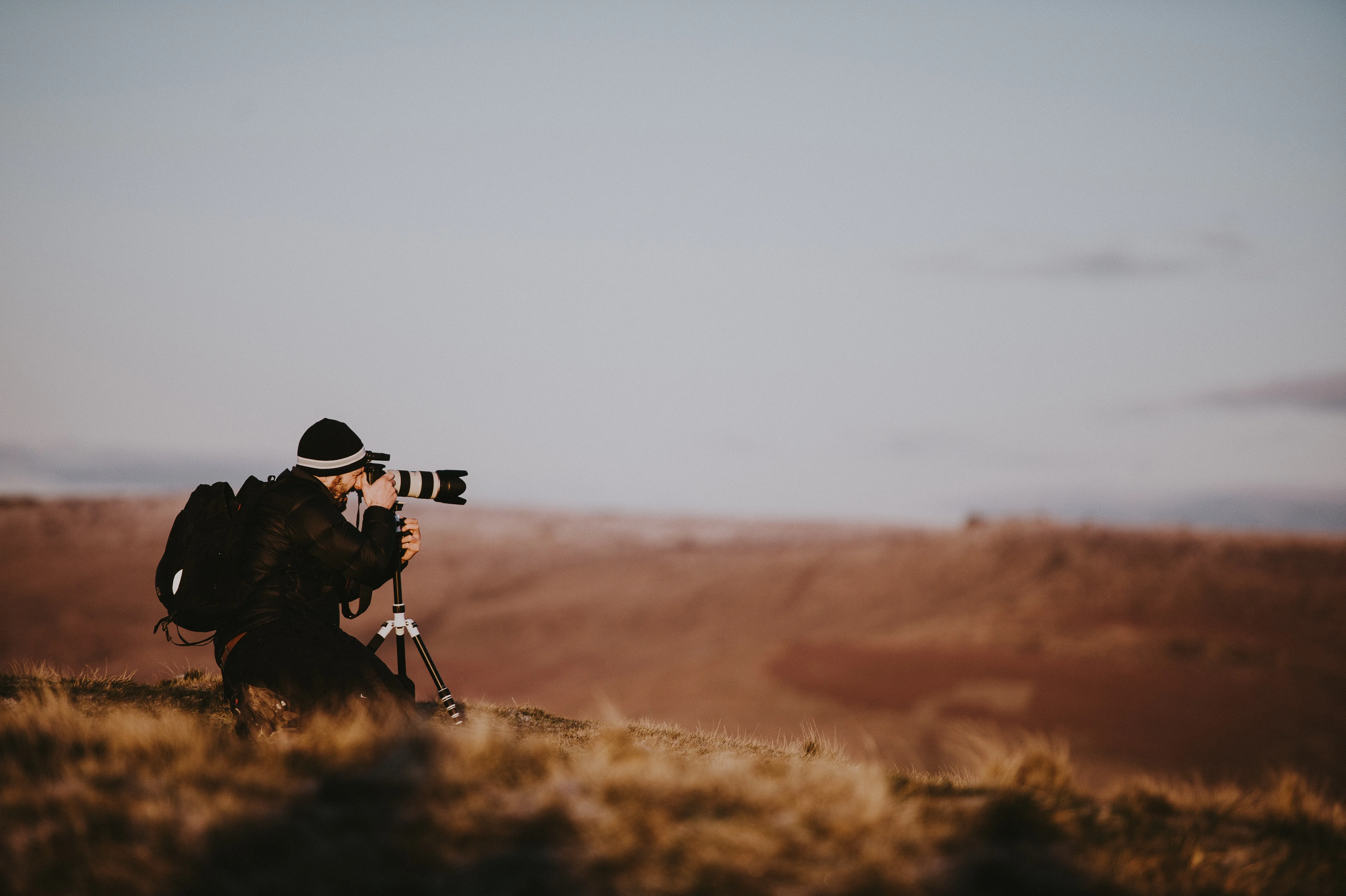 a man with a camera taking a picture of a landscape