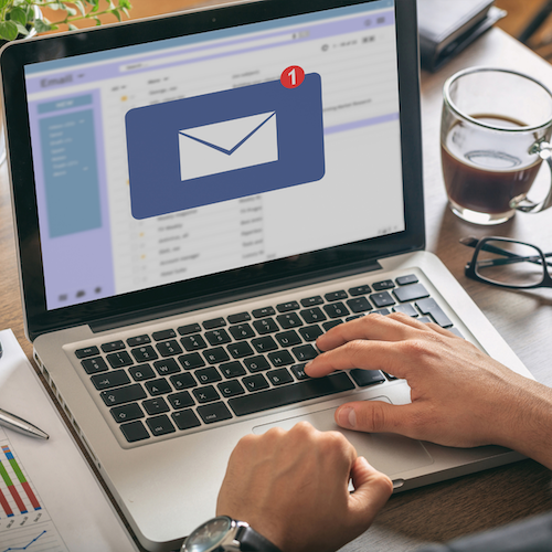 Enlarged email icon displayed on a laptop screen.
