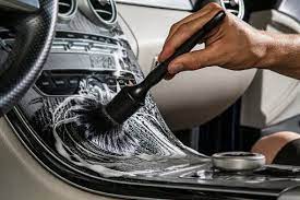 Brush cleaning a vehicle center console