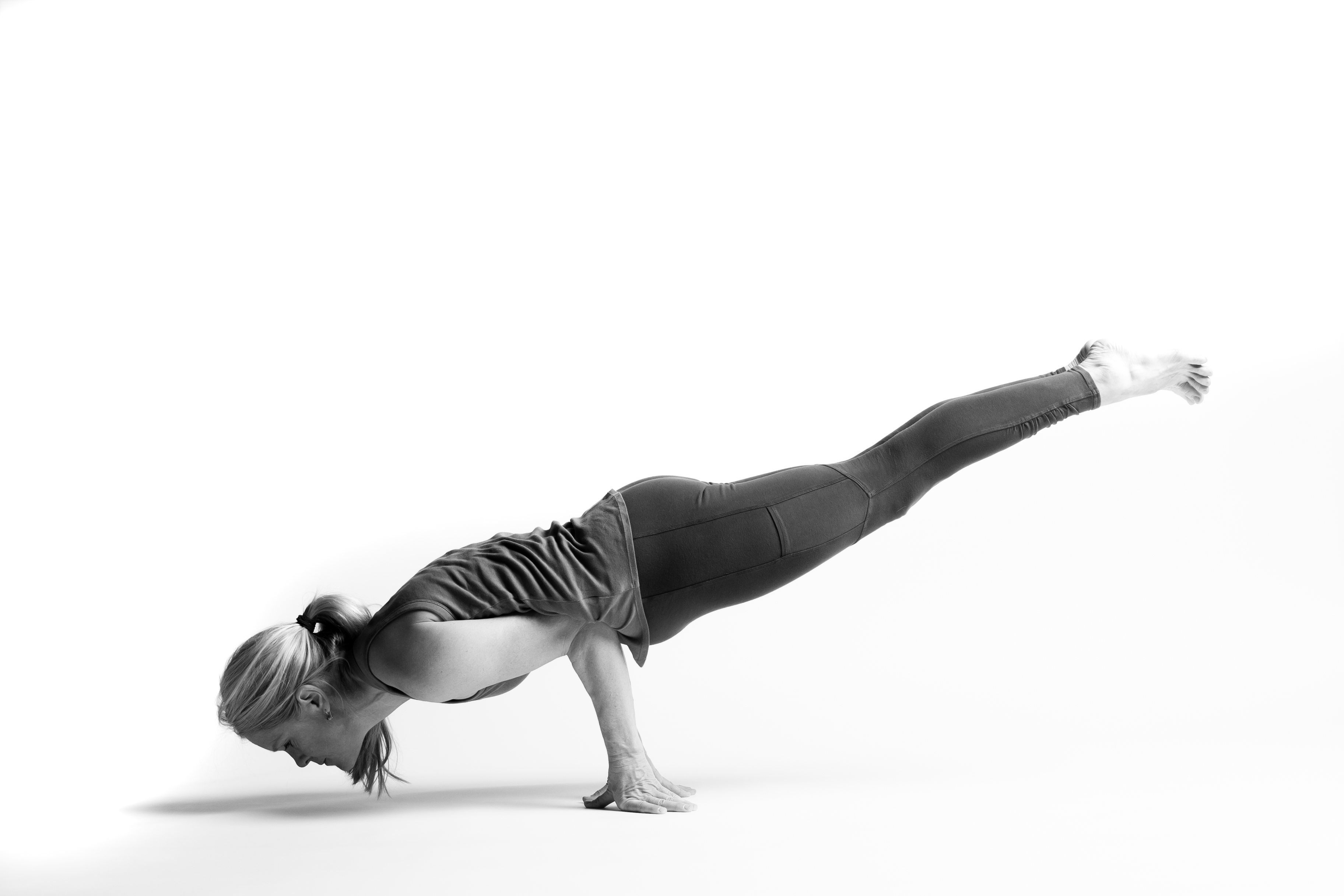 Woman balancing on her hands in Peacock Pose