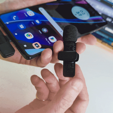 USB-C receiver plugged into a phone, indicator light on.