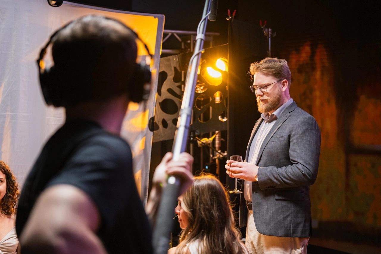 Decorative

Description: A lecturer stands on set with a mic operator in the foreground