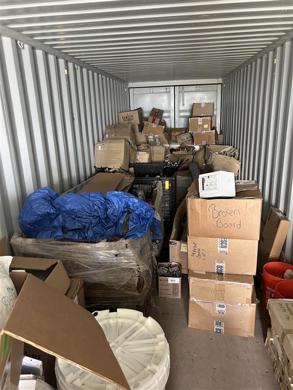Enfinity spare parts storage before Ventory: unsorted boxes and pallets in a container