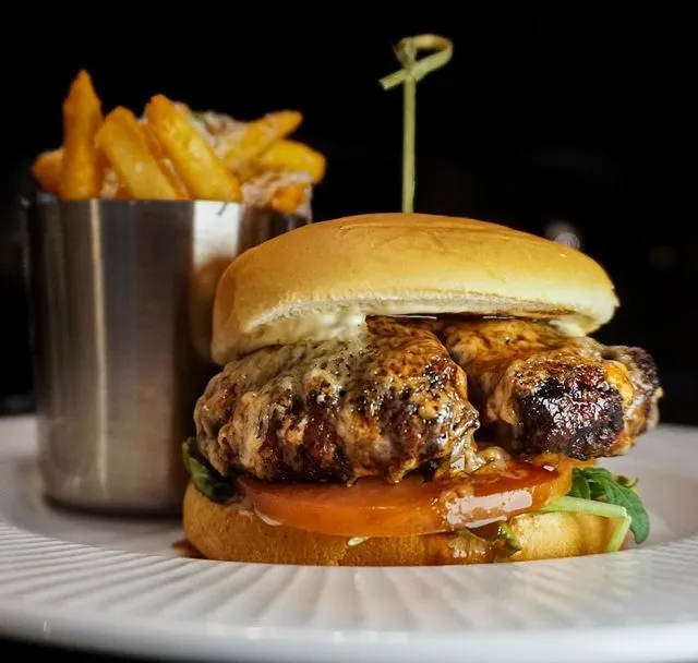 Juicy cheeseburger with fries at The Grill On 21, Chicago, IL