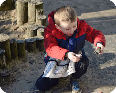 A picture of boy playing and wearing Tales Toolkit apron