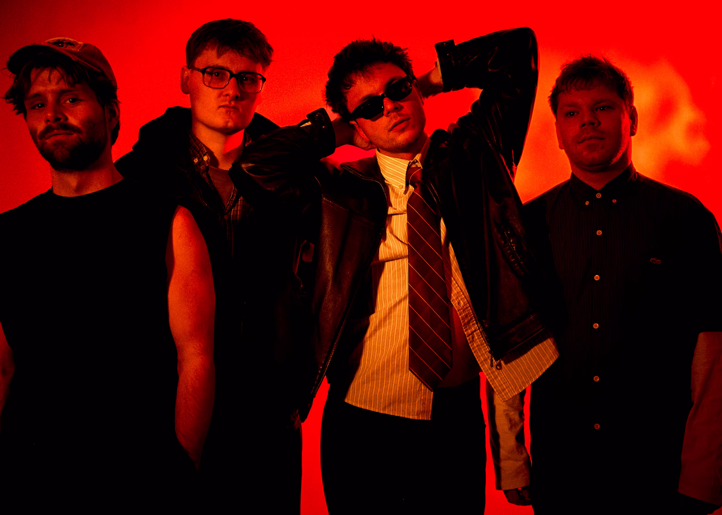 The band Razz: 4 men in black clothing against a red-orange background