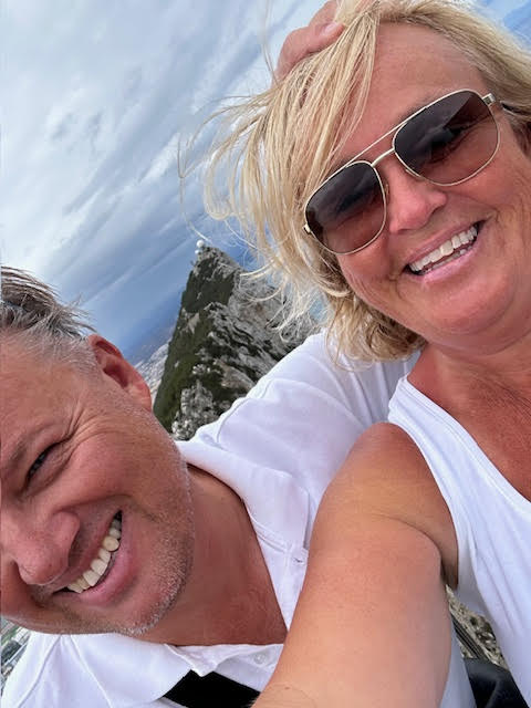 A couple looking at a beautiful sunset at the beach