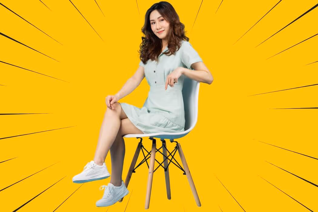 Sitting cross legged in chair with arm on the back