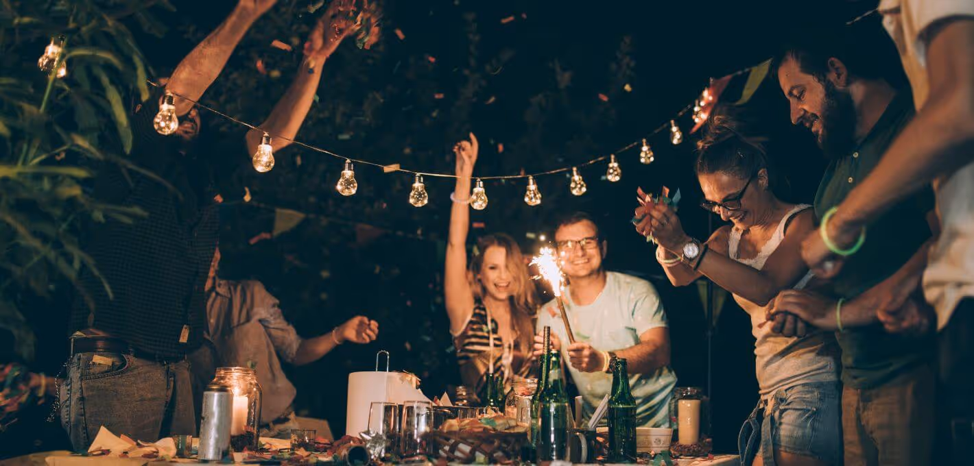 Outdoor night party with sparkler and string lights