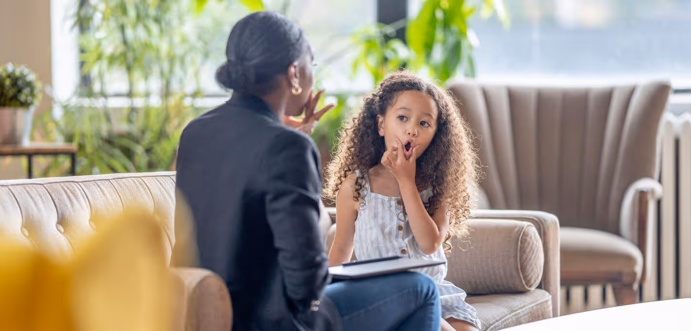 Child and therapist sitting on a couch