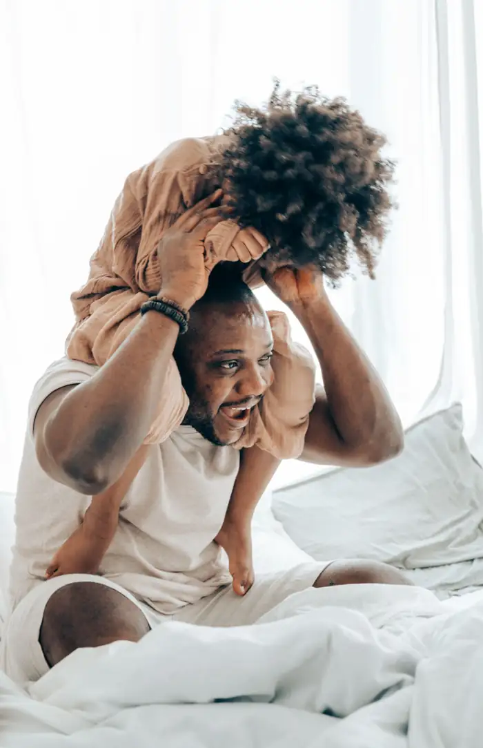 Father playing with his child at home