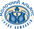 Logo of ‘Молочний Альянс’ (Molocnhyi Alyans), a dairy company group. The design features two traditional milk jugs forming a heart shape, with a clover above them, enclosed in an oval frame. The text is written in Ukrainian, curved around the emblem in blue and beige colors.