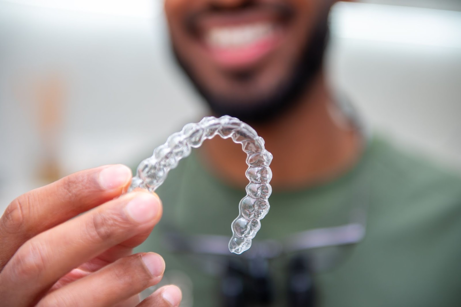 Clear Invisalign style aligner shown by dentist at Feel Good Dental Croydon
