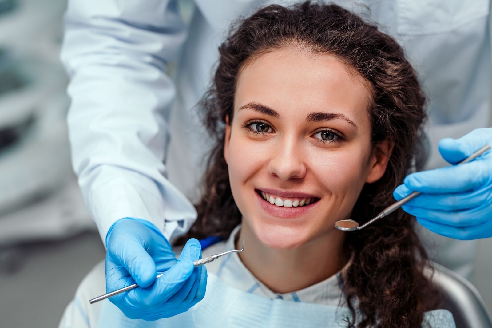Patient smiling during dental examination before crown treatment