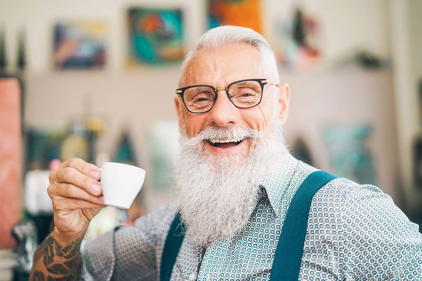 Smiling older man enjoying coffee after dental implant treatment restoring confidence in his smile