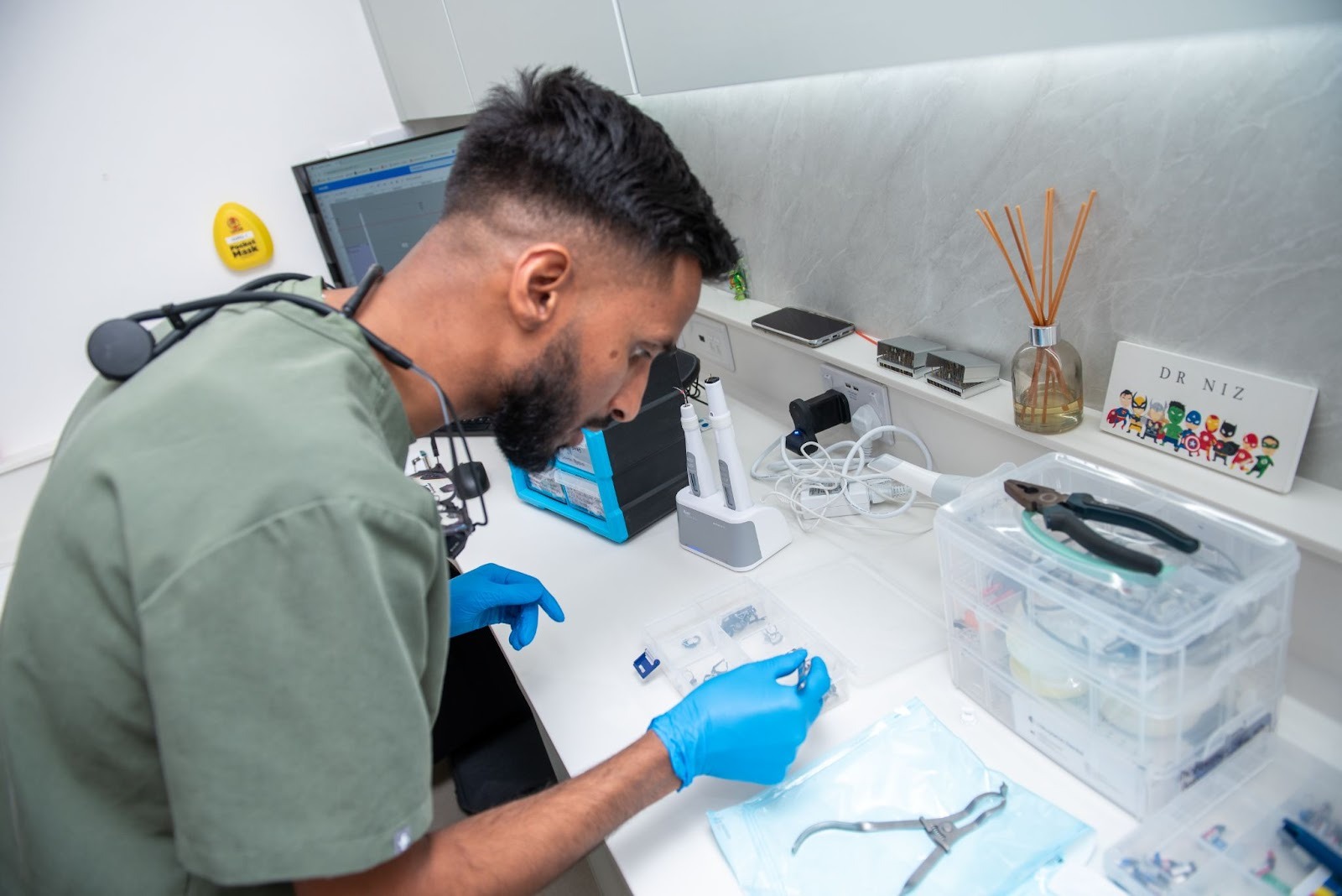 Implant dentist preparing dental implant components and instruments before implant placement procedure