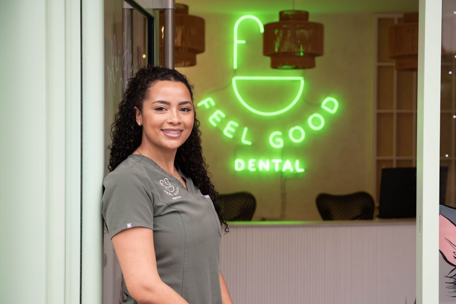 Dental hygienist Leah standing outside Feel Good Dental practice in Croydon welcoming cosmetic dentistry patients