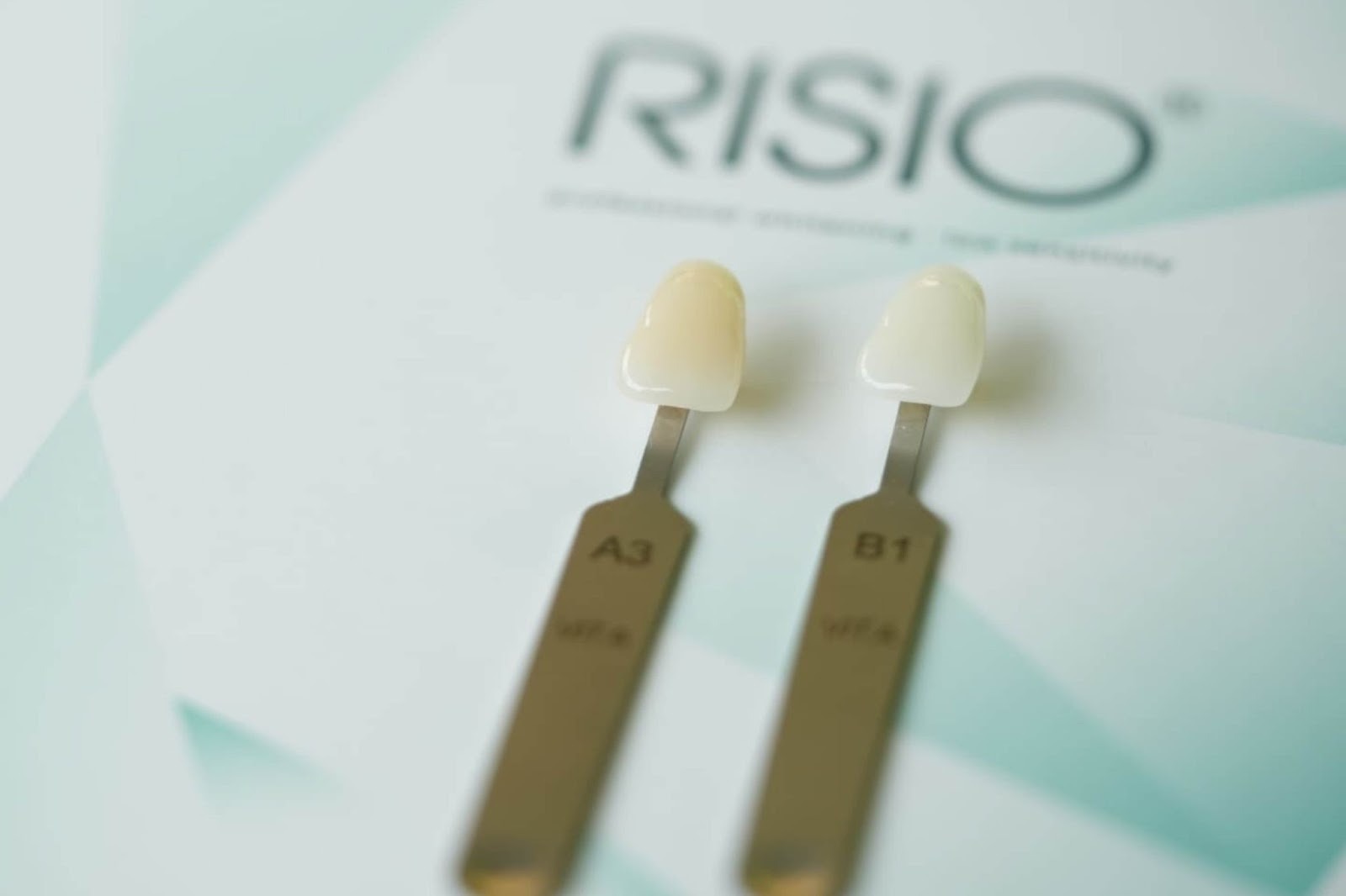 Close-up of dental shade samples used to match composite bonding material to natural tooth colour