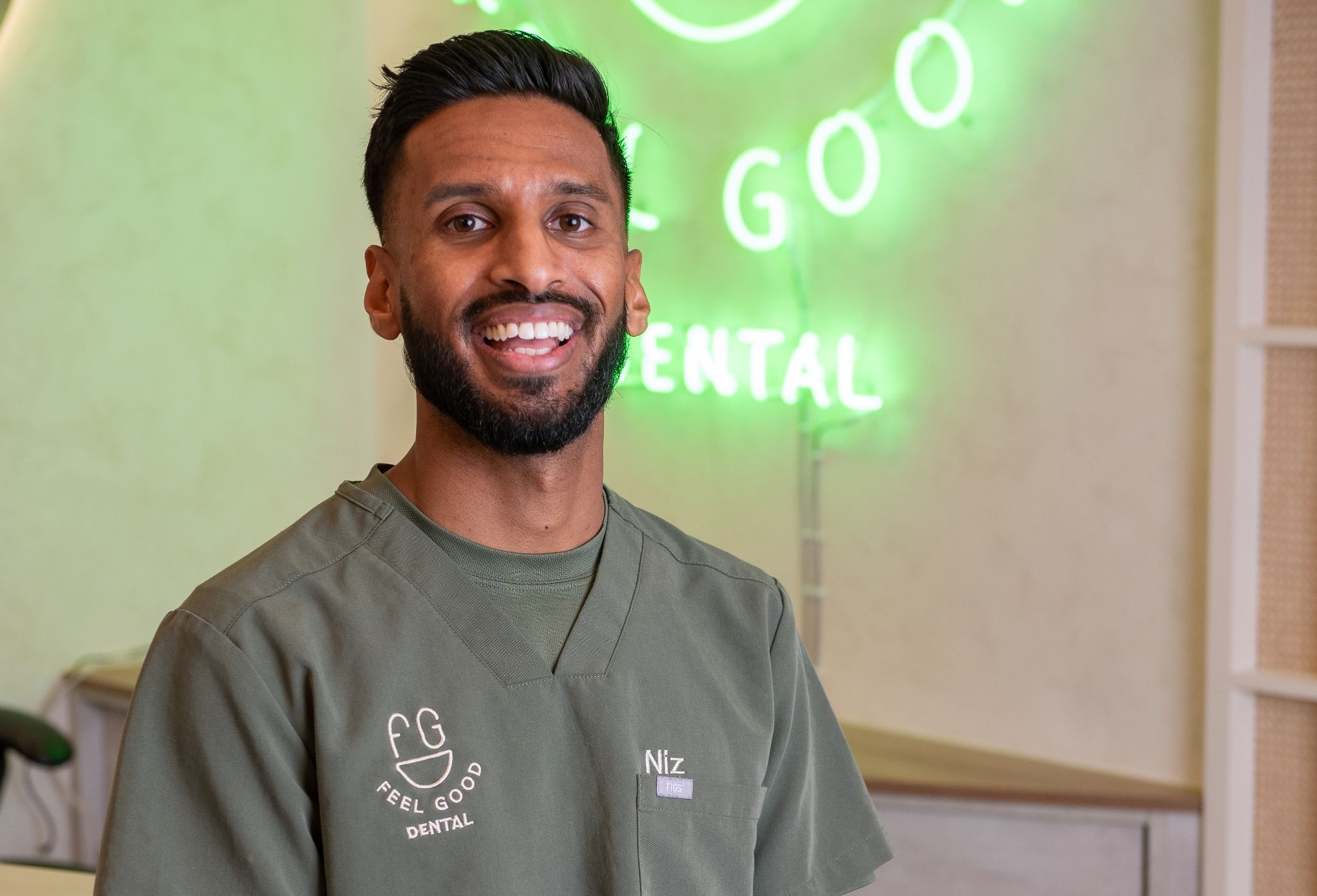 Dr Niz Patkunan, principal dentist at Feel Good Dental Croydon welcoming patients for filling consultations