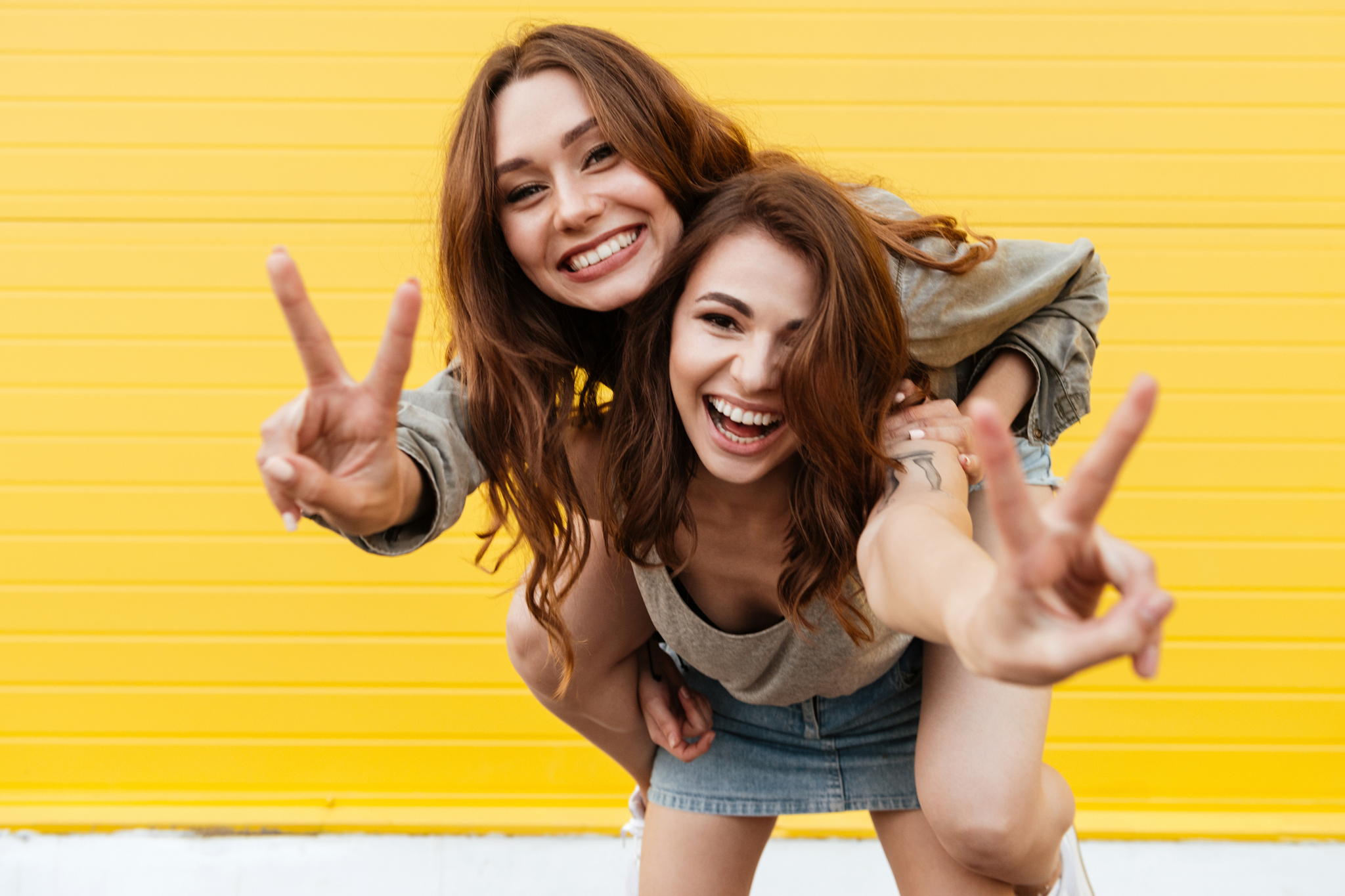 Two women smiling confidently after cosmetic dental treatment at Feel Good Dental Croydon