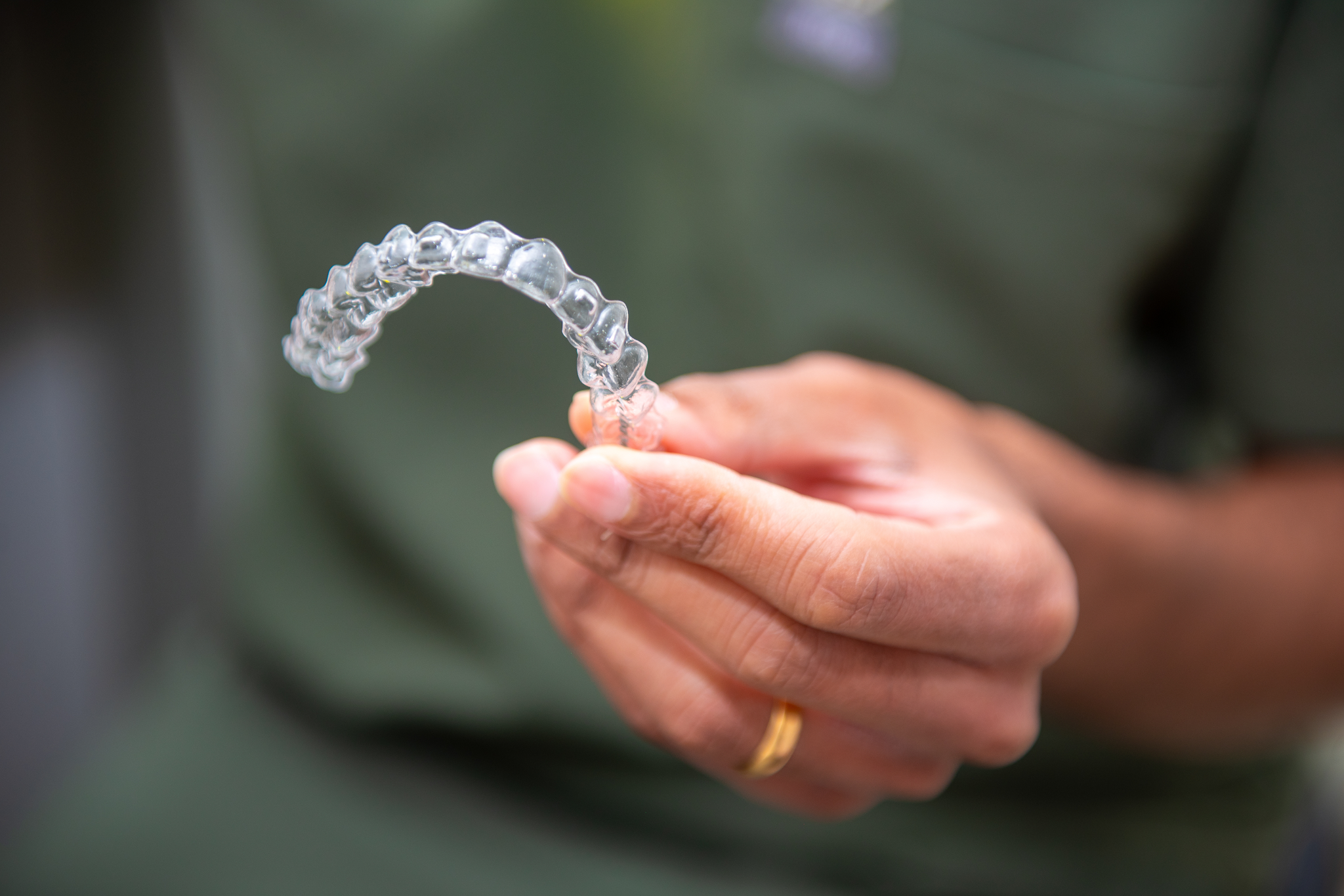 Invisalign clear aligner held by dentist at Invisalign provider in Croydon