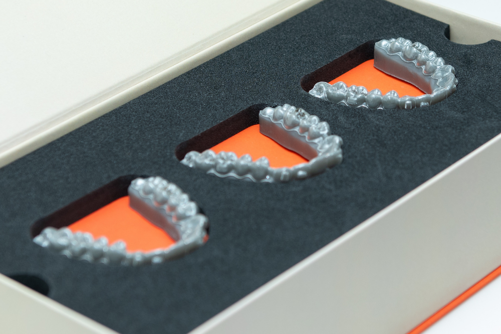 Custom Invisalign clear aligners prepared for teeth straightening treatment