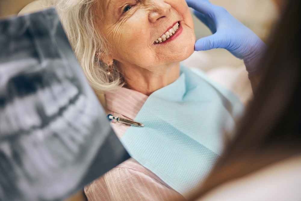 Older patient having a dental implant consultation with a dentist in Croydon