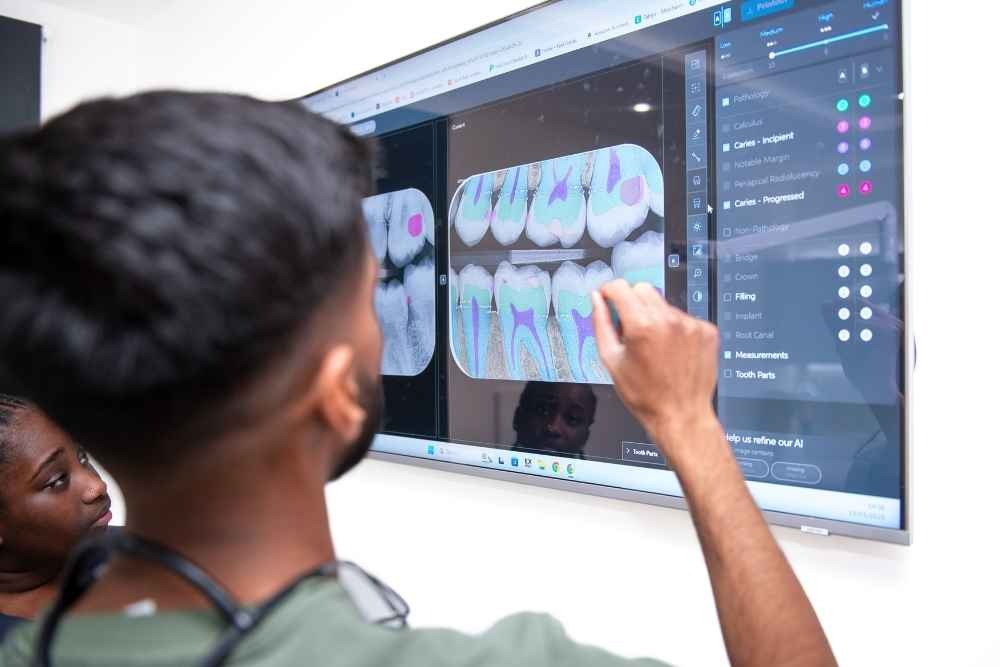 Dentist reviewing digital dental scans before dental implant treatment