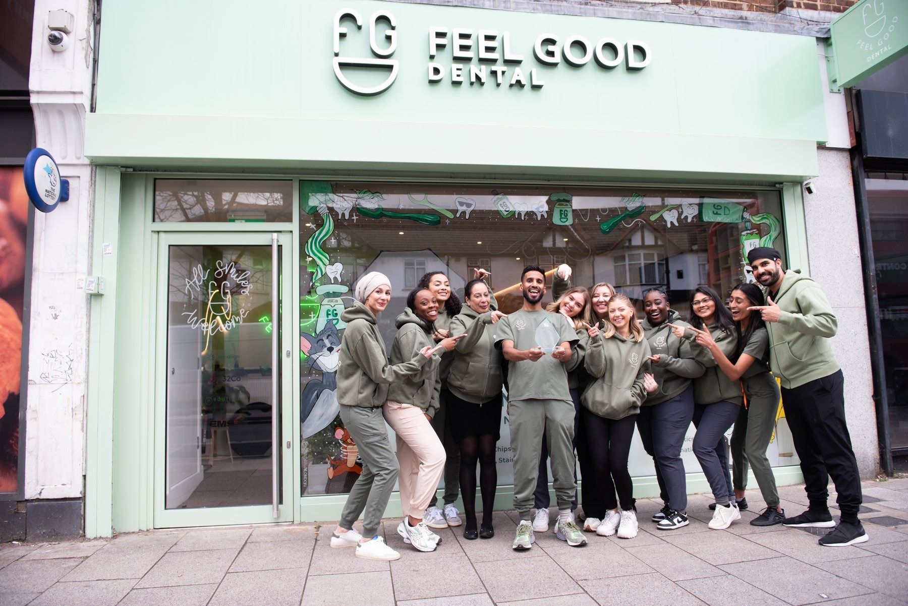 The Feel Good Dental team smiling together outside the practice on Lower Addiscombe Road, Croydon