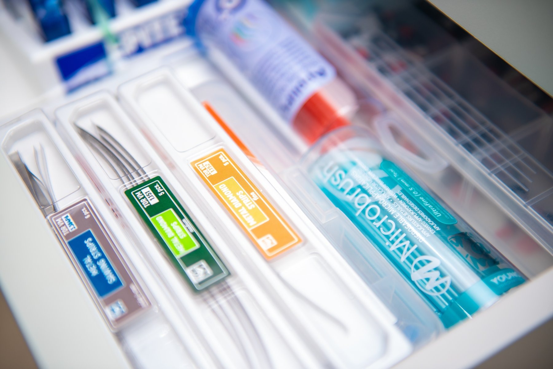 A drawer containing interdental brushes and toothpaste at Feel Good Dental