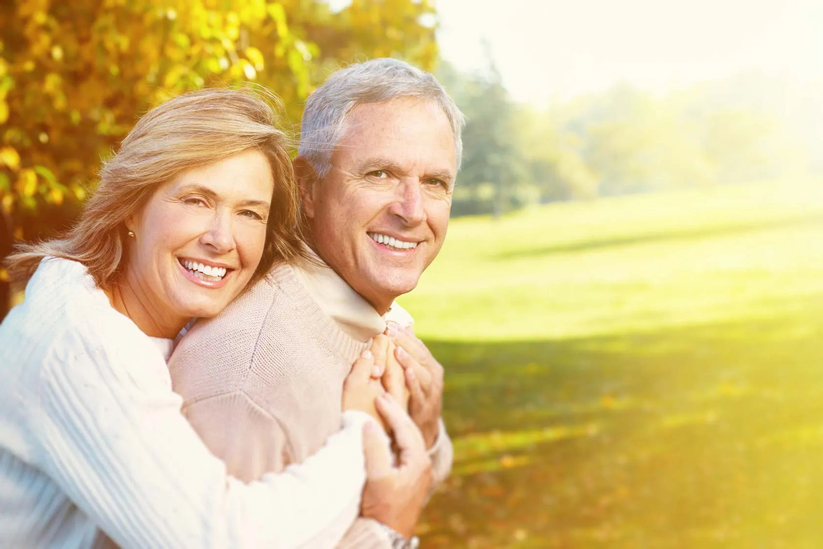 Older couple smiling after All-on-4 dental implants at Foxley Lane Dental, trusted Purley dentist near Coulsdon and Croydon