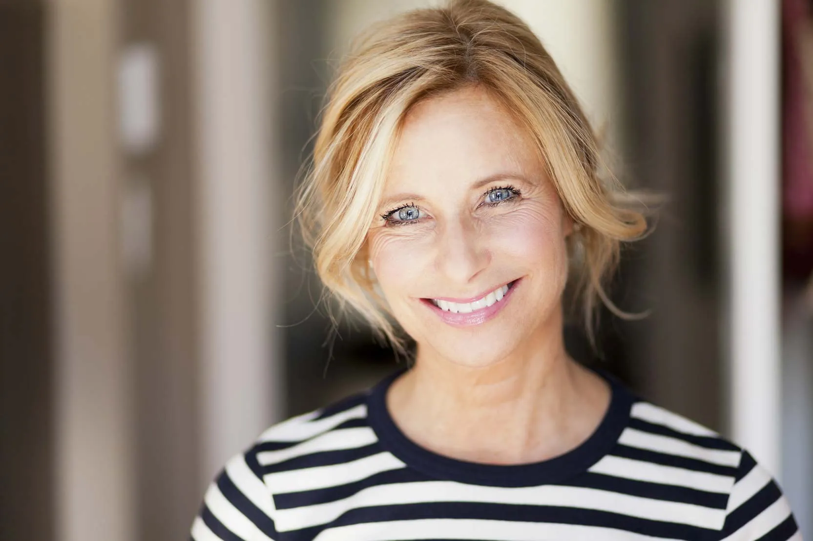 Smiling woman after All-on-4 dental implants at Foxley Lane Dental, trusted Purley dentist near Croydon